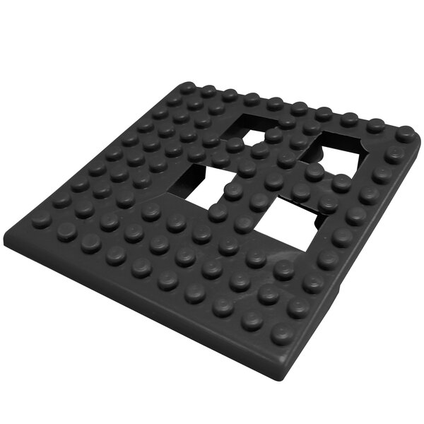 A black interlocking vinyl corner piece with holes in it.