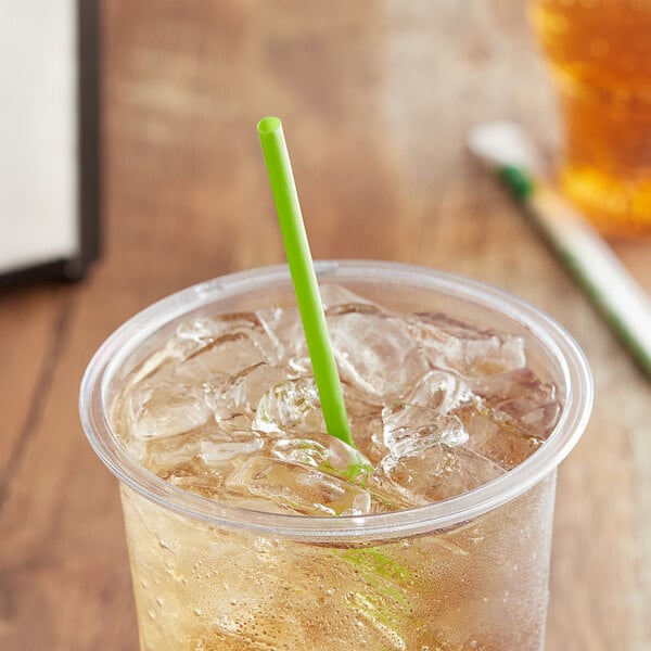 A clear plastic cup with ice tea and a green EcoChoice PLA straw.