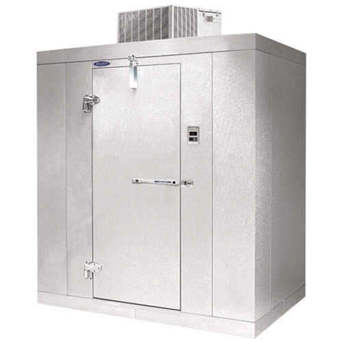 A white metal Norlake Kold Locker walk-in freezer with the door open.