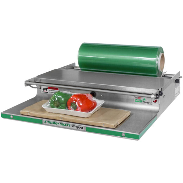 A Bizerba countertop wrapping machine sealing a package of red and green peppers.