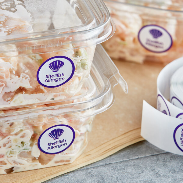 Plastic containers of food with Point Plus purple shellfish allergen labels.