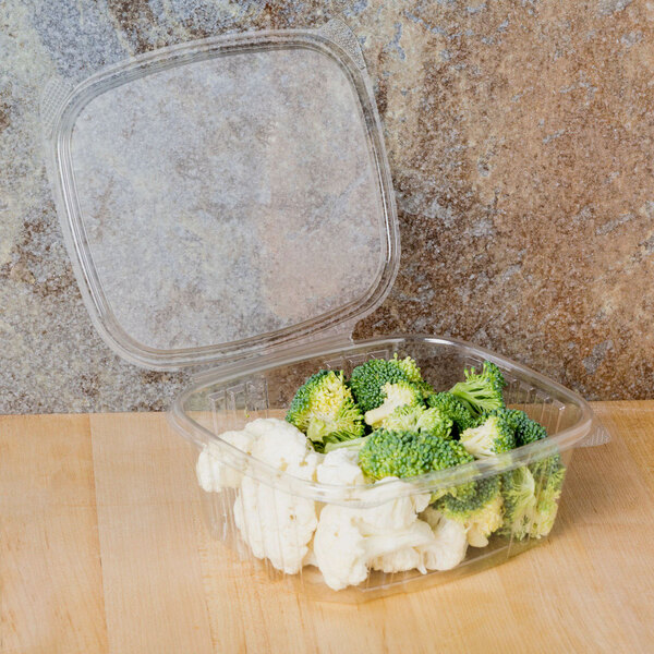 A Genpak clear plastic deli container filled with broccoli and cauliflower.