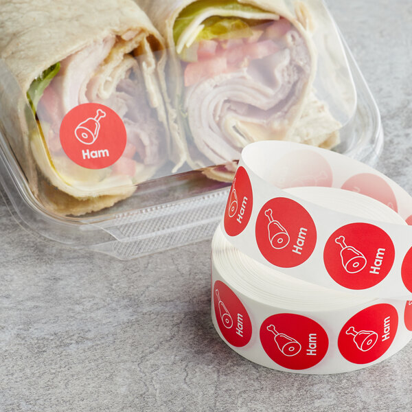 A wrap sandwich with a red Point Plus Ham sticker on the plastic wrap.