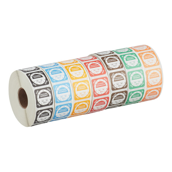 A roll of dissolvable day of the week clock labels in various colors, each labeled with a different day.