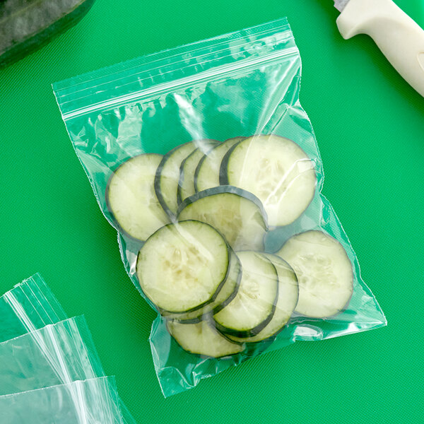 A Clear Line plastic bag of sliced cucumbers on a table.