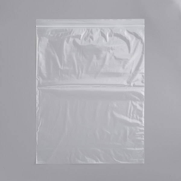 A clear plastic bag on a white surface with a grey background.