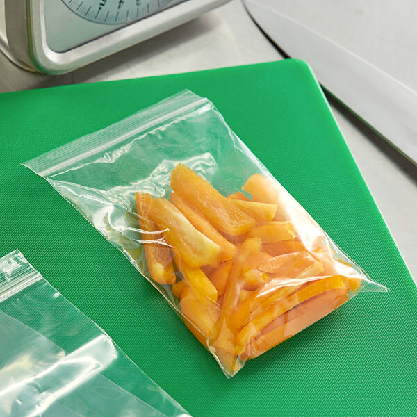 A Clear Line plastic food bag of sliced carrots on a cutting board.