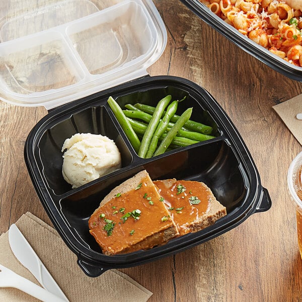 A Choice plastic container with three compartments holding pasta with sauce and cheese.