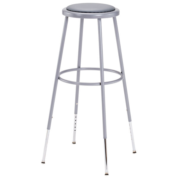 A National Public Seating gray lab stool with a padded round seat and adjustable gray legs.