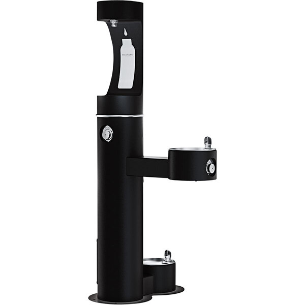 An Elkay black vertical outdoor water bottle filling station with a drinking fountain.