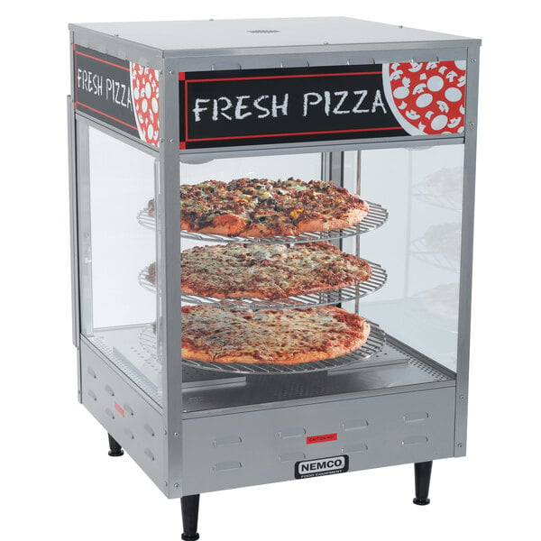A Nemco countertop pizza merchandiser with pizza in it.
