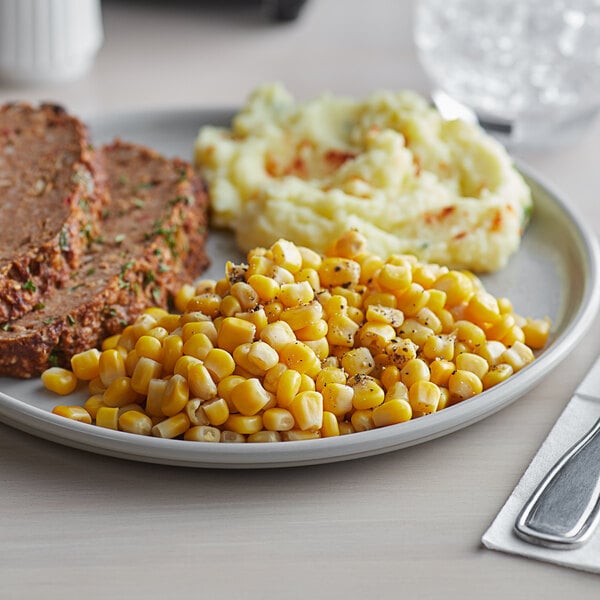 A plate of meatloaf, mashed potatoes, and Regal whole kernel sweet corn on the side.