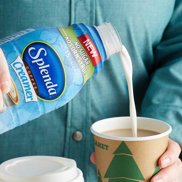 A person pouring Splenda French Vanilla coffee creamer into a cup of coffee.