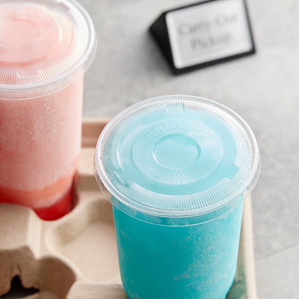 Choice clear plastic lids on two plastic cups filled with pink and blue frozen drinks on a tray.