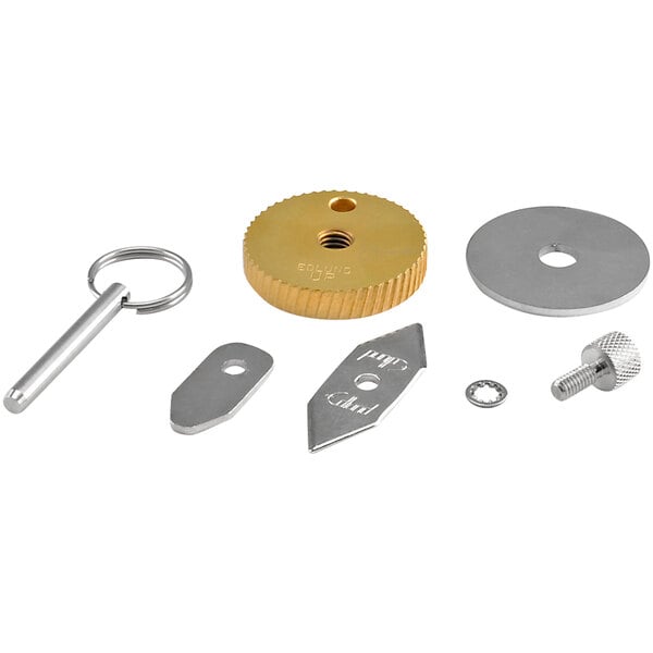 A group of silver metal parts including a blade and gear with a key.
