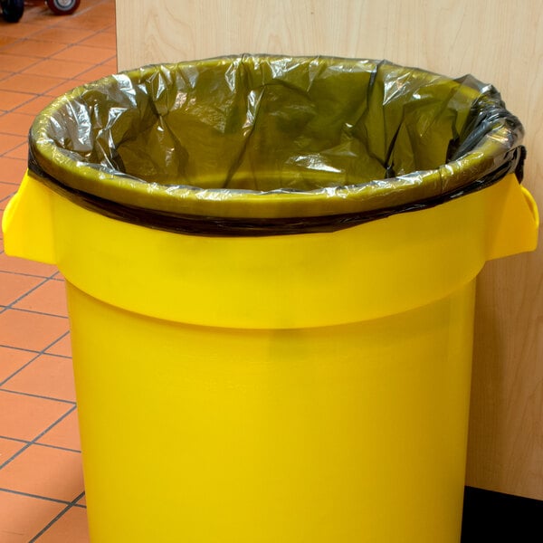 A yellow garbage can with a black plastic bag inside.