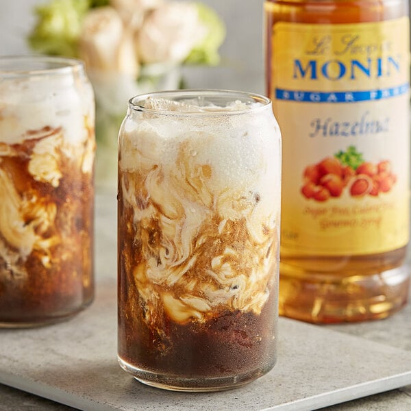 Two glasses of iced coffee with Monin Sugar Free Hazelnut syrup in it.