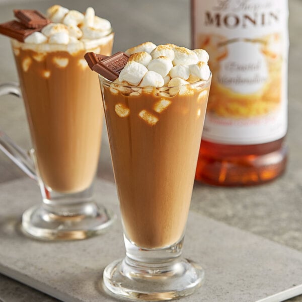 Two glasses of hot chocolate with Monin toasted marshmallow syrup and marshmallows.