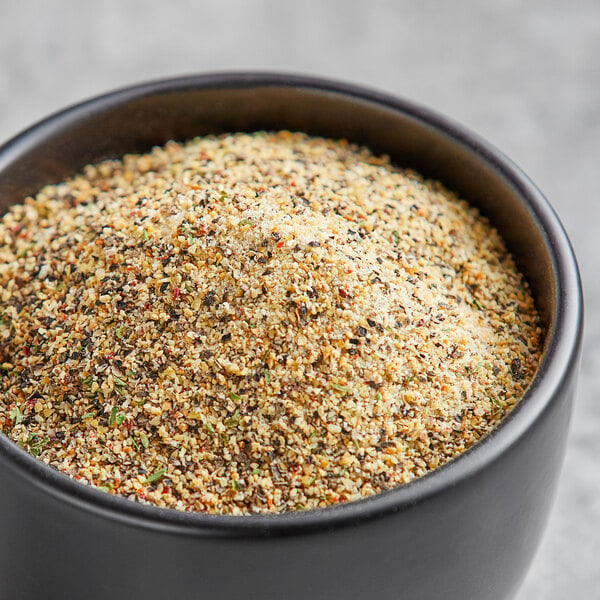 A bowl of Lawry's Garlic Pepper Seasoning on a table.