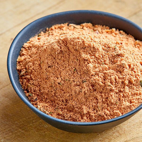 A bowl of Lawry's Mexican rice seasoning mix on a wooden table.