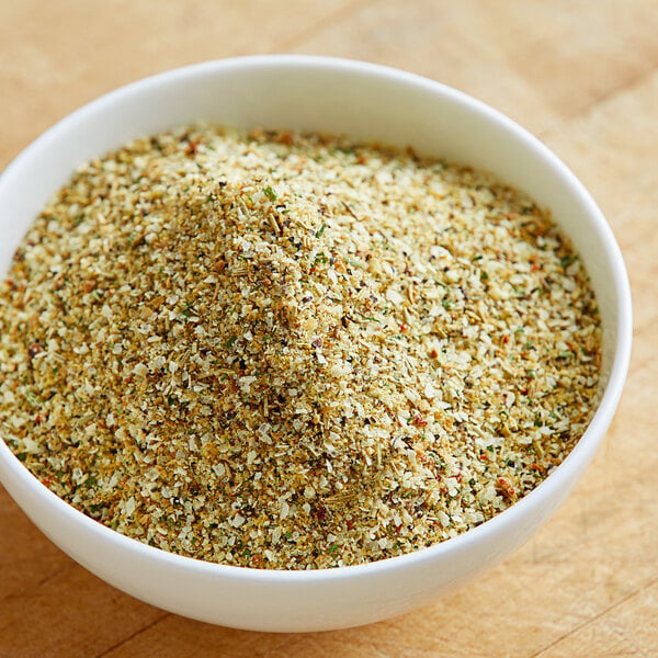 A bowl of Lawry's Garlic, Rosemary, and Lemon Rub on a wood surface.