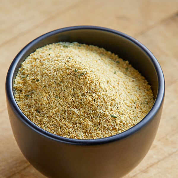 A bowl of Lawry's Coarse Grind Garlic Powder with Parsley on a table.