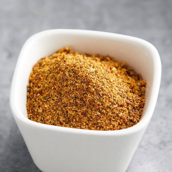 A white bowl filled with Lawry's Salt-Free Lemon and Pepper Seasoning.