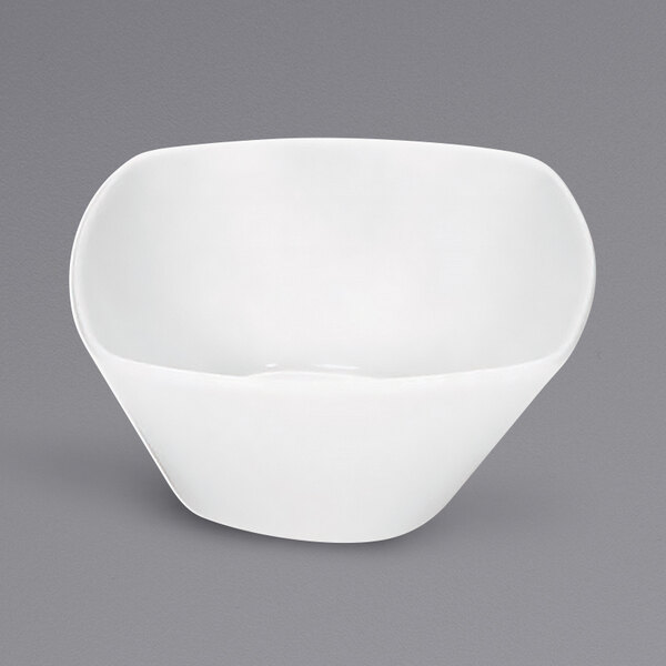 A Bauscher bright white square porcelain cream soup bowl with a small handle.