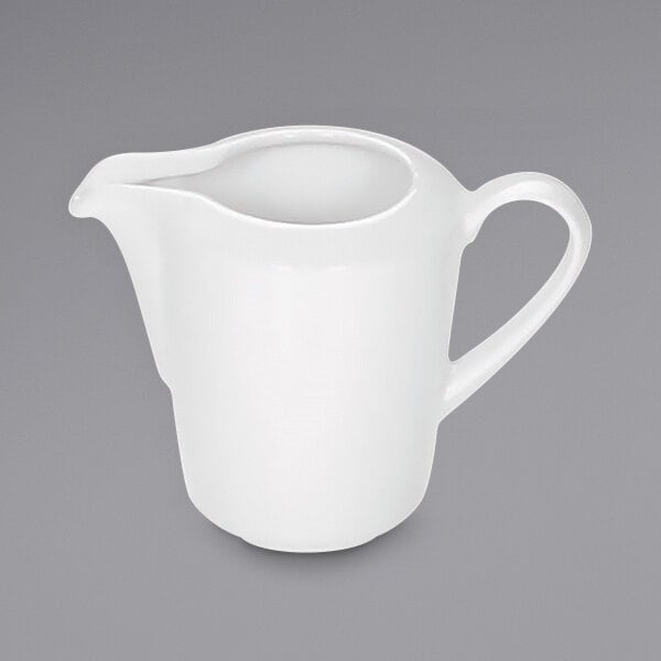 A white Bauscher porcelain pitcher with a handle.