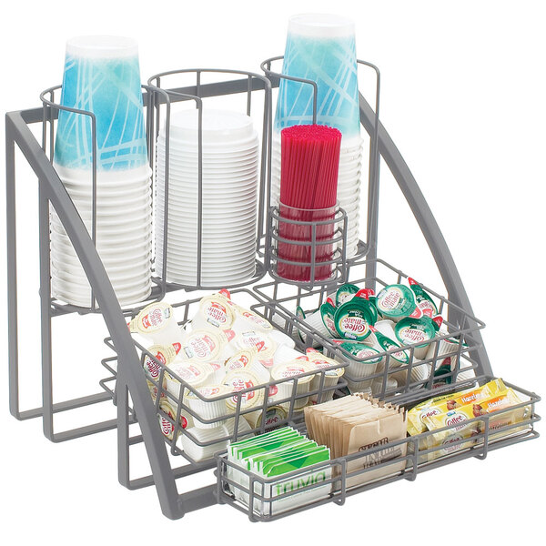 A metal Cal-Mil condiment organizer with cups and condiments inside.