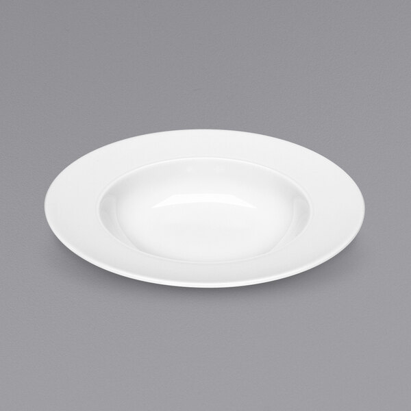 A Bauscher white porcelain deep plate with a shadow on a gray surface.