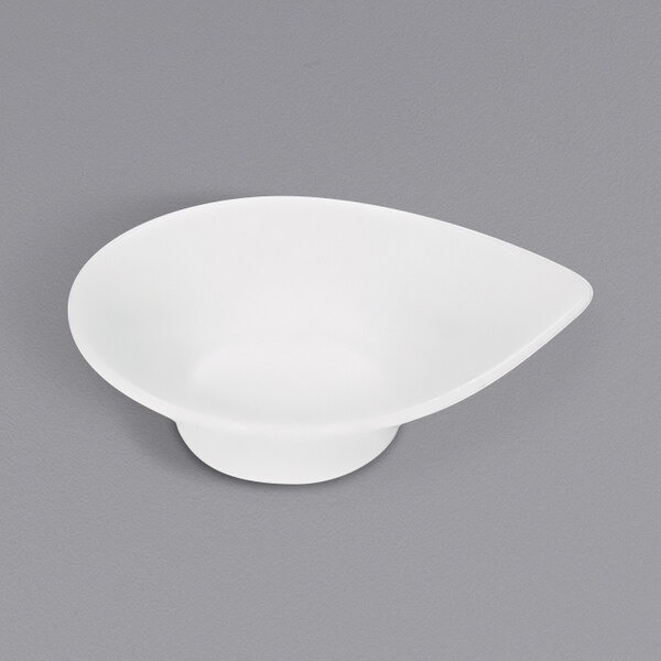 A bright white teardrop-shaped sauce boat.