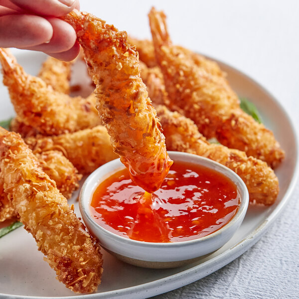 A plate of fried shrimp with THAI Kitchen Sweet Red Chili Sauce for dipping.