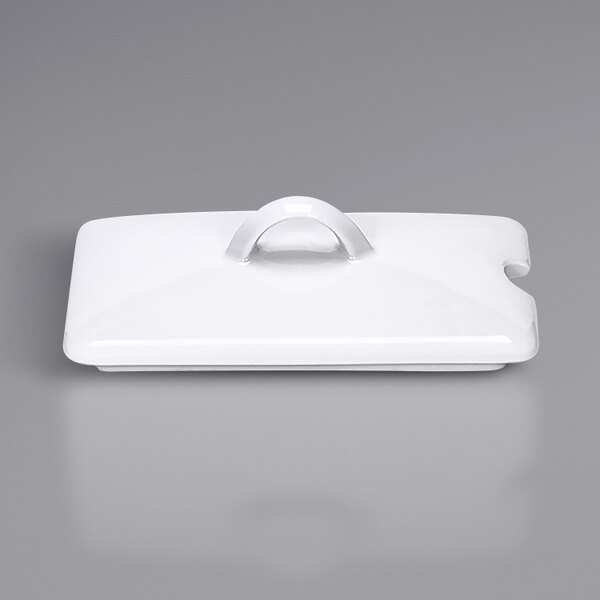 A white rectangular porcelain lid with a handle.