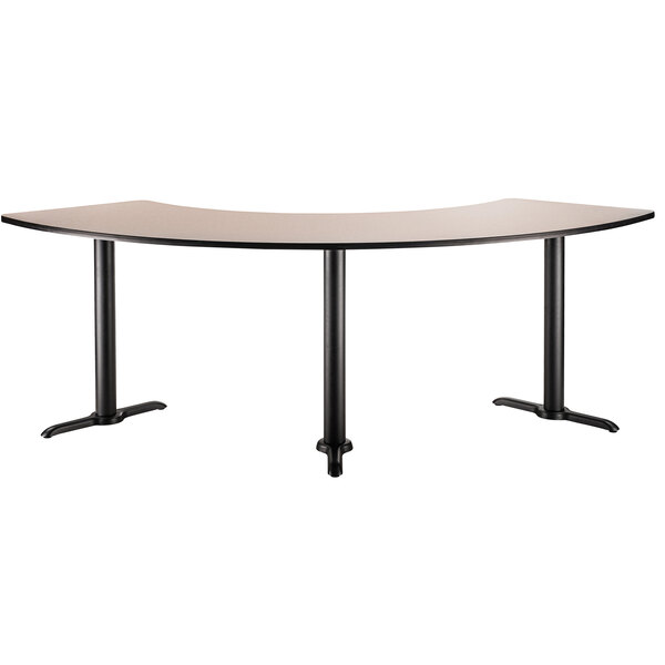 A National Public Seating curved cafe table with black frame.