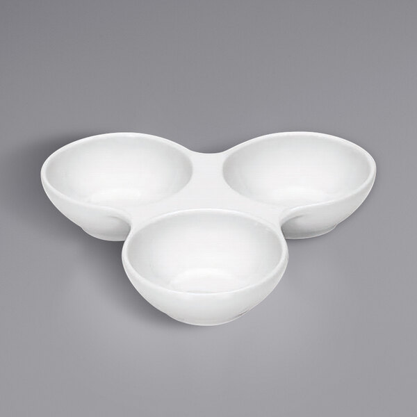 Three Bauscher bright white tear-shaped porcelain cruet bowls on a white surface.