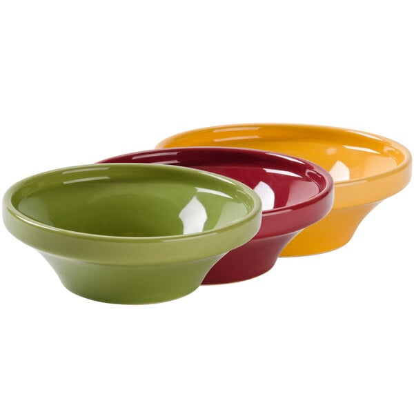 A group of Tuxton wide mouth soup bowls in assorted colors.