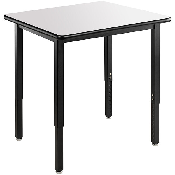A rectangular table with black legs and a white top.