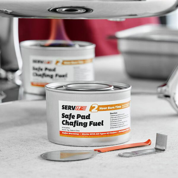 A can of ServIt chafing dish fuel with a safe pad on a counter.
