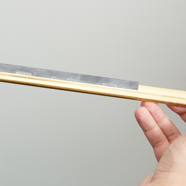 A hand holding a Unger ErgoTec squeegee blade with a metal bar.