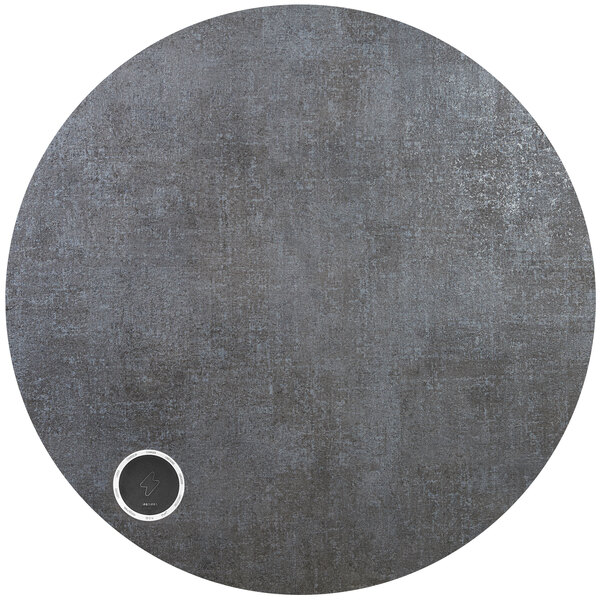 A BFM Seating Midtown round grey tabletop with a round silver circle in the center