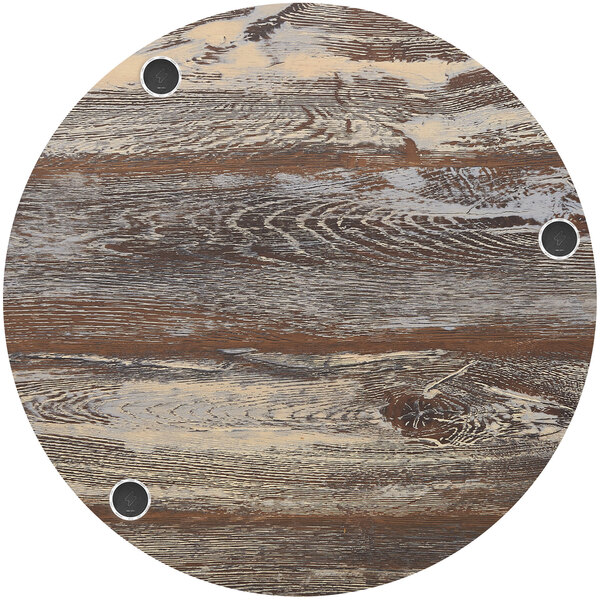 A BFM Seating round wood table top with wireless charger holes.