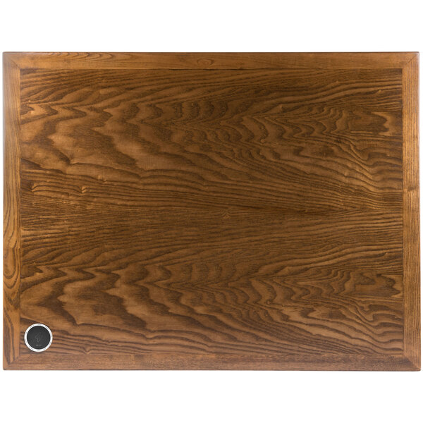 A BFM Seating rectangular wooden table top with a round hole in the middle with a metal ring inside.