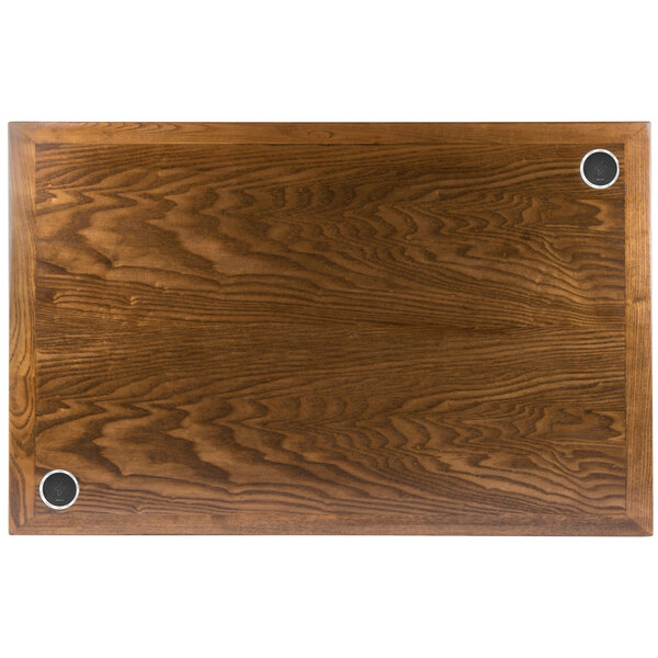 A BFM Seating rectangular wood table top with two wireless charger circles.