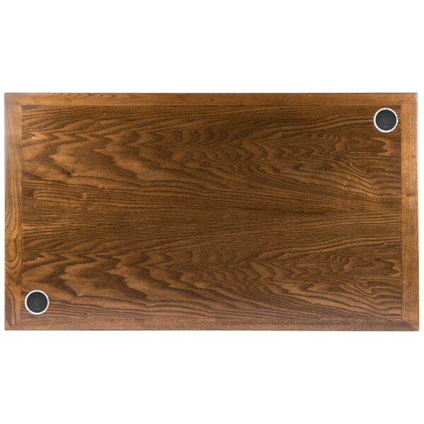 A BFM Seating rectangular wood table top with two round holes.