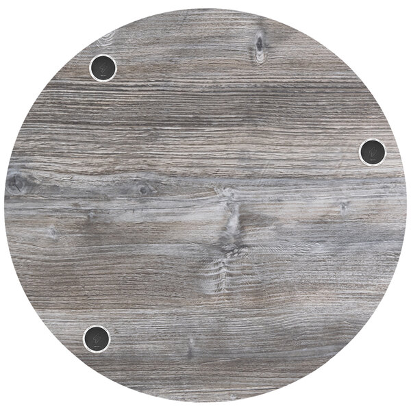 A BFM Seating Midtown round wood table top with holes in it.