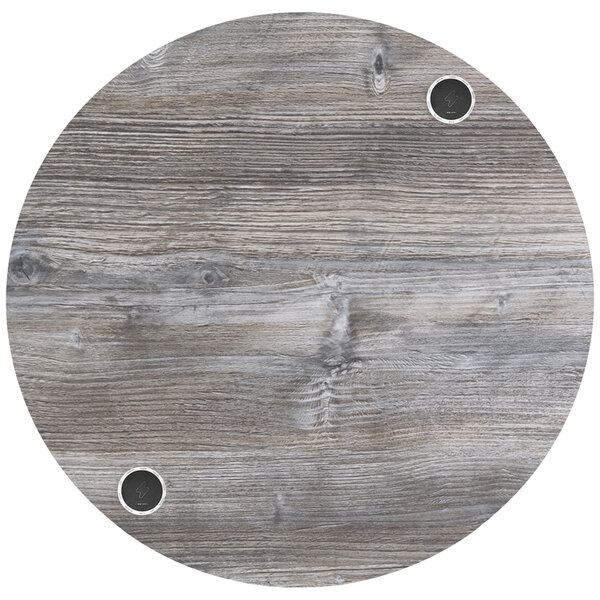 A BFM Seating Midtown round wooden table top with holes in it.