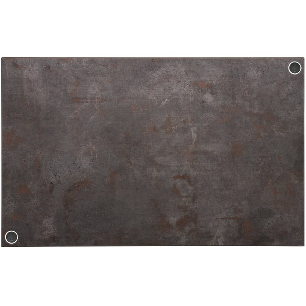 A rectangular metal BFM Seating table top in a rust colored finish with two wireless chargers.