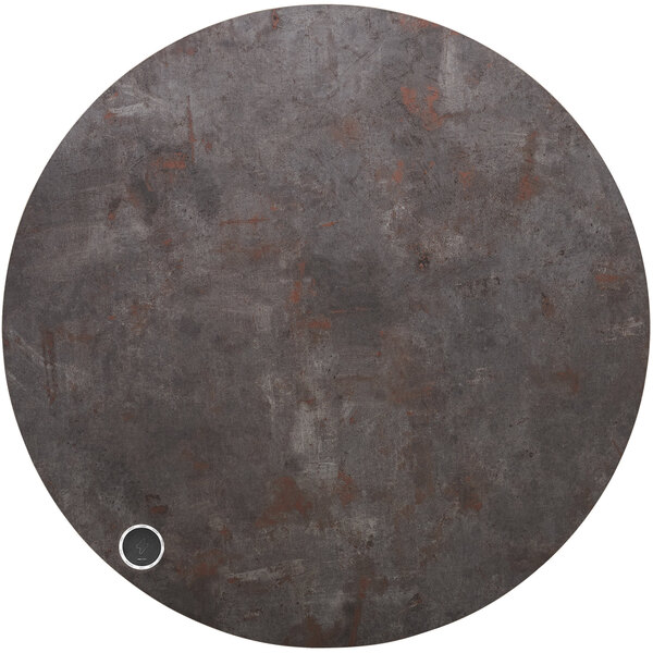 A BFM Seating Relic round copper metal table top with a small circular metal charger area.