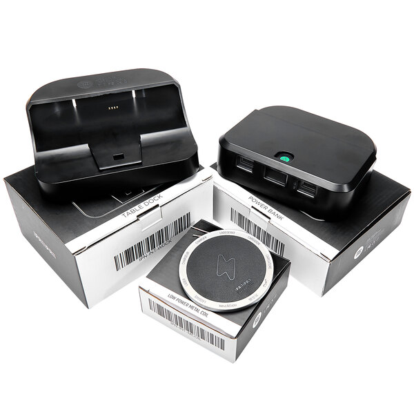 Three black rectangular BFM Seating wireless charging stations with barcodes on them.